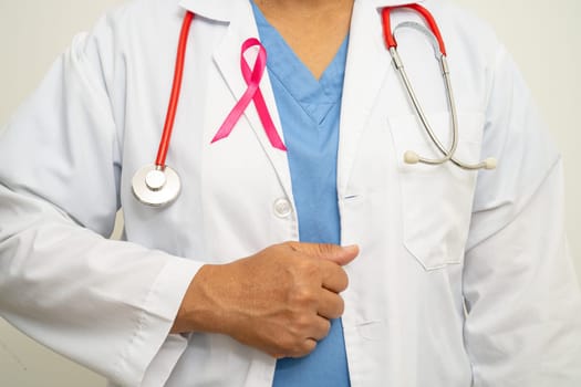 Breast cancer, Asian doctor woman with pink ribbon, symbol of World Breast Cancer Day.