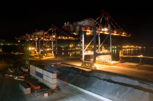 Sea port container terminal during work at night in fog. High quality photo