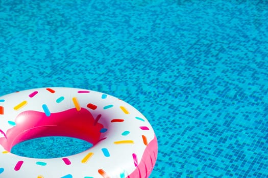 Inflatable ring, inspired by everyone's favorite doughnut, awaits in the inviting swimming pool