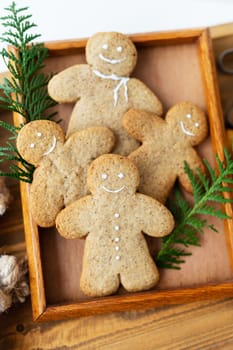 Gingerbread Man. Cooking gingerbread cookies at home lies on a wooden tray. The concept of the holiday of Christmas and New Year