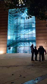 theater and people, night street modern building windows architecture. High quality photo
