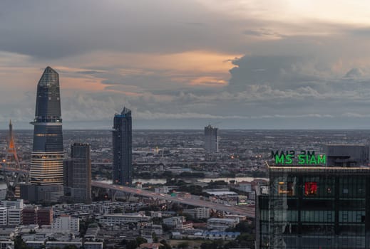 Bangkok, Thailand - Aug 22, 2024 - City view with KingBridge tower alongside the iconic landmark of Bhumibol Bridge and MS Siam Tower at Evening. Stunning skyline of bangkok business district with Skyscrapers at before sunset use it as your wallpaper, poster and banner design, Selective focus.