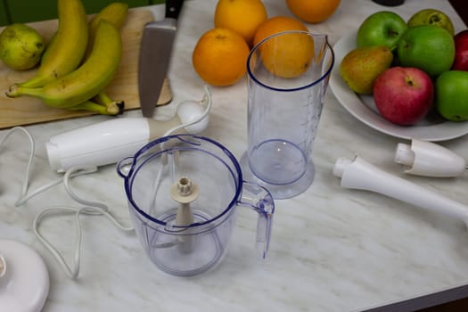 Blender containers next to fruits on table to create healthy sports drink. Items for making fruit juice in blender for healthy lifestyle