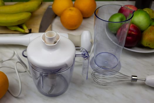 Blender and fruits on the table, healthy eating and lifestyle concept, making fruit cocktail with vitamins for sports nutrition