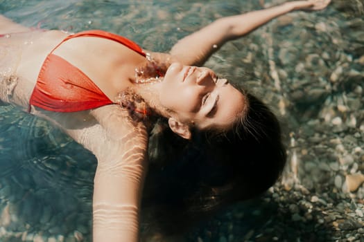 Happy woman sea relaxing floating in transparent sea water on summer holiday. Travel leisure recreation lifestyle, female in nature