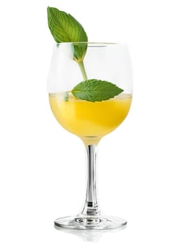 Belgian Jenever in tulip glass garnished with slice of lemon and sprig of green mint. Drink isolated on transparent background.