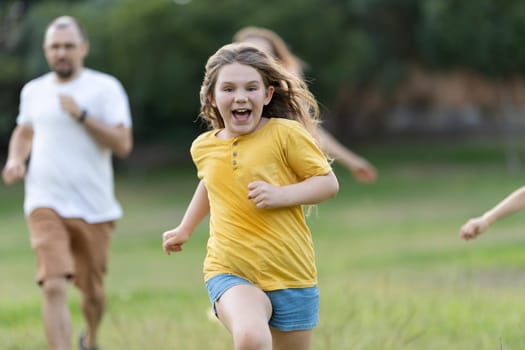 Family is running and playing together in a park, enjoying their free time