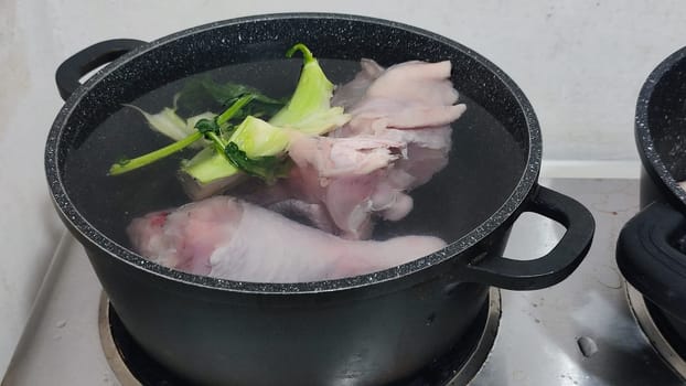chicken leg in a saucepan for broth, food lunch cooking preparation dinner, products. High quality photo