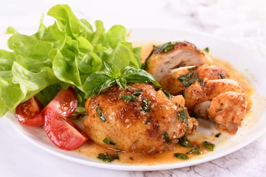 Chicken thigh with gravy and vegetable side dish
