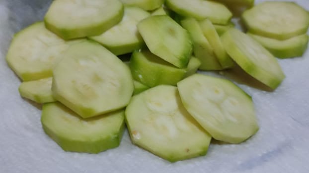 healthy food, green zucchini slices and onions in a frying pan. High quality photo