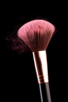 A conceptual photo of an applicator brush with dust coming off it.