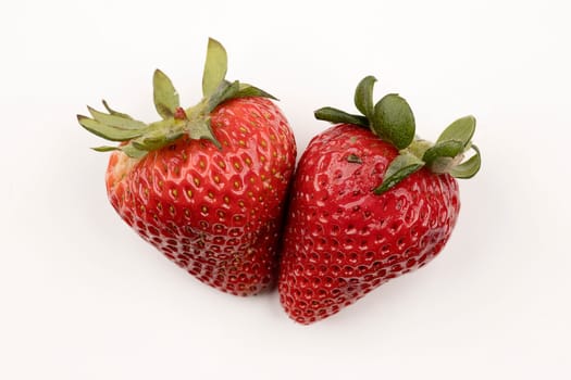 Two delicious and fresh strawberries are on a pure white background.