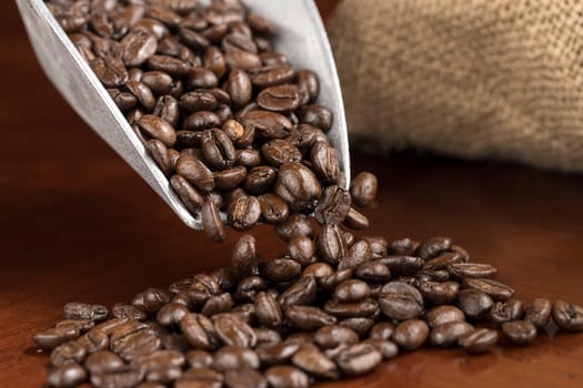 A studio concept photo of pouring coffee beans into a pile.