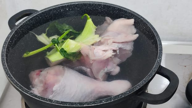 chicken leg in a saucepan for broth, food lunch cooking preparation dinner, products. High quality photo