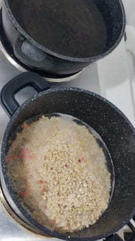 oatmeal porridge in a saucepan, healthy food on the stove, cooking lunch dinner breakfast. High quality photo