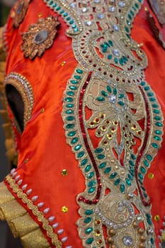 Bright orange is a traditional elephant decoration in India. Textile. With rhinestones and embroidery. Religion and traditions.