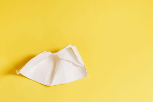 Damaged, unusable disposable plastic cup on a yellow background. Plastic waste.