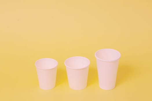 Take away a cup of coffee on orange paper background.