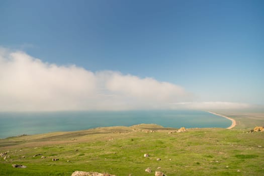 A beautiful blue ocean with a cloudy sky in the background