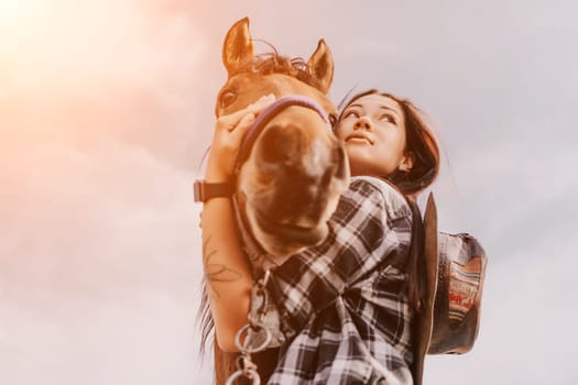 A young woman with long black hair and a plaid shirt holds a brown horse's face in her arms, their gazes meet, revealing a deep bond.
