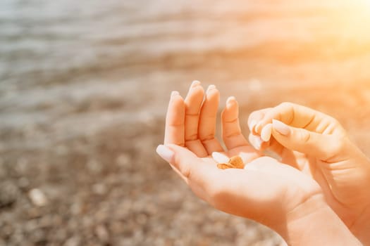 Woman eating milky almond nuts. A young caucasian woman choping fresh green almond after morning fitness yoga near sea. Only hands are visibly. Healthy vegan food. Slow motion. Close up