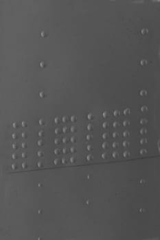 Vertical photo of the metal skin with rivets of an old airplane.