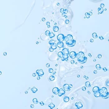 Bubbles float elegantly through clear water, reflecting light and creating a serene atmosphere. The scene captures the beauty of water movement in a tranquil environment.