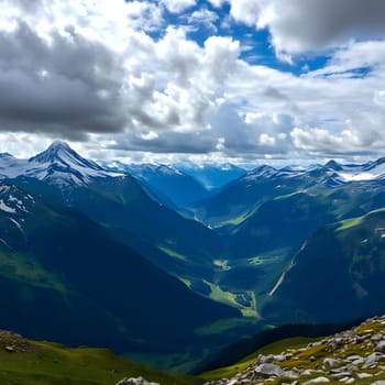 Majestic peaks and green valleys stretch widely under a sky filled with fluffy clouds. The brilliant colors and vast expanses create a breathtaking view of nature's beauty during summer.