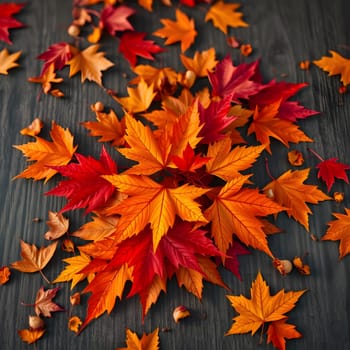 A vibrant collection of orange and red autumn leaves is spread across a rustic wooden surface, embodying the beauty of fall with their rich colors and textures.
