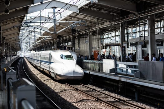 KYOTO, JAPAN - MAY 13, 2019: A Shinkansen high-speed bullet train pulling into a train station in Japan