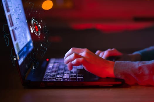 Problems with unprotected data in the workplace are under threat of hacking, female hands are typing on the keyboard in close-up, trying to pass verification, icons, drawn lock above the laptop.