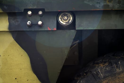 Close-up of an armored personnel carrier in camouflage colors, a military themed background.