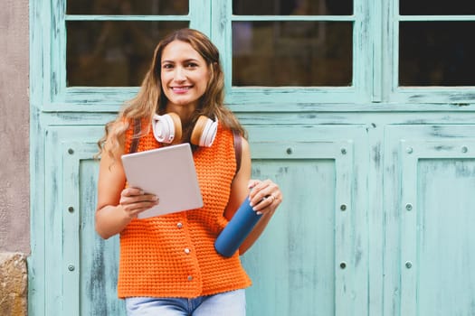 Portrait of a modern latin woman with digital tablet and reusable bottle of water