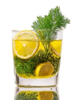 Danish Snaps in shot glass garnished with slice of lemon and sprig of fresh dill. Drink isolated on transparent background.