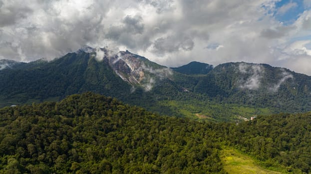 Active Sibayak volcano and mountains with forest. Sumatra, Indonesia.