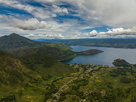 Aerial view of mountains with forest and Lake Toba. Samosir Island. Sumatra, Indonesia.