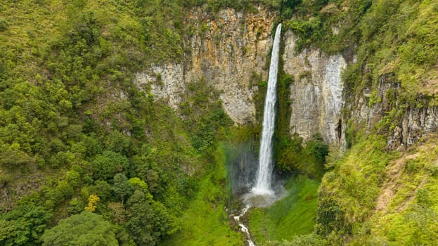 Waterfall in the tropical mountain jungle. Sipiso Piso falls. Sumatra, Indonesia.