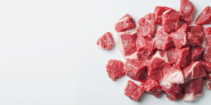 Fresh raw meat chunks on white background for carnivore diet concept and culinary design.