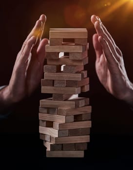 Plan and strategy in business, Risk To Make Business Growth Concept With Wooden Blocks, hand of man has piling up and stacking a wooden block.