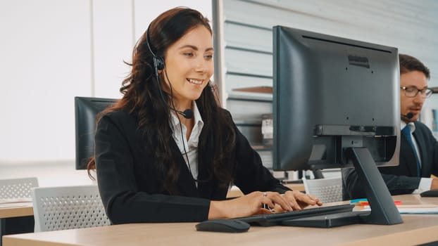 Business people wearing headset working in office to support remote customer or colleague. Call center, telemarketing, customer support agent provide service on telephone video conference call. Jivy