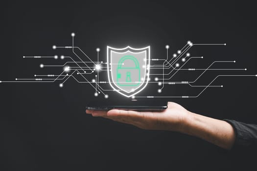 Safeguard personal and business information on smartphones with a cybersecurity concept. Business people prioritize data security using encryption and key icons on virtual interface shields.