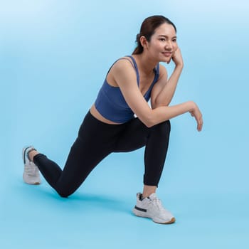 Young attractive asian woman in sportswear stretching before fitness exercise routine. Healthy body care workout with athletic woman warming up on studio shot isolated background. Vigorous