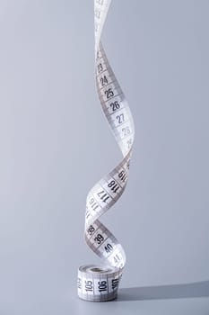 Dieting concept. colorful measuring tapes top view on gray background