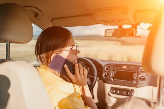 Relaxed business woman talking on video call on phone in automobile. Rested female professional saying bye on video chat in business car. Beautiful lady making video message in luxury car.