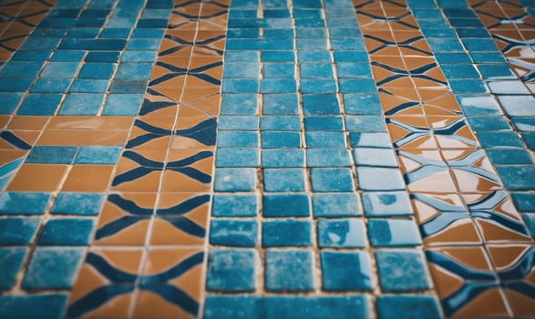 A close-up shot of a floor tiled with small blue and brown squares. The pattern of the tiles creates a repeating design