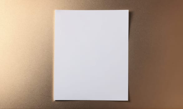 A white sheet of paper with a pattern of tiny white dots on its left side, the paper is positioned on a brown surface.