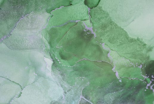 The artwork features a vibrant tapestry of green hues in a fluid arrangement, creating a captivating abstract design that highlights its unique textures and depth.