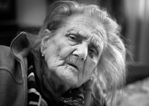 Black and white portrait of very old tired woman in depression. Old woman. 