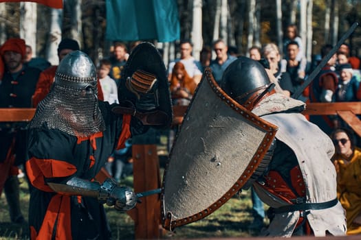 Spectators revel in an exhilarating and thrilling medieval knight duel during an exciting reenactment event