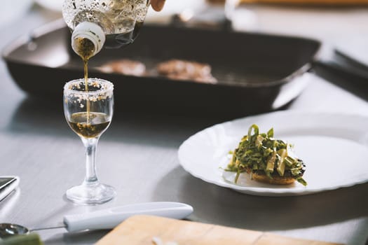 Chef serves food on the plate in restaurant close-up